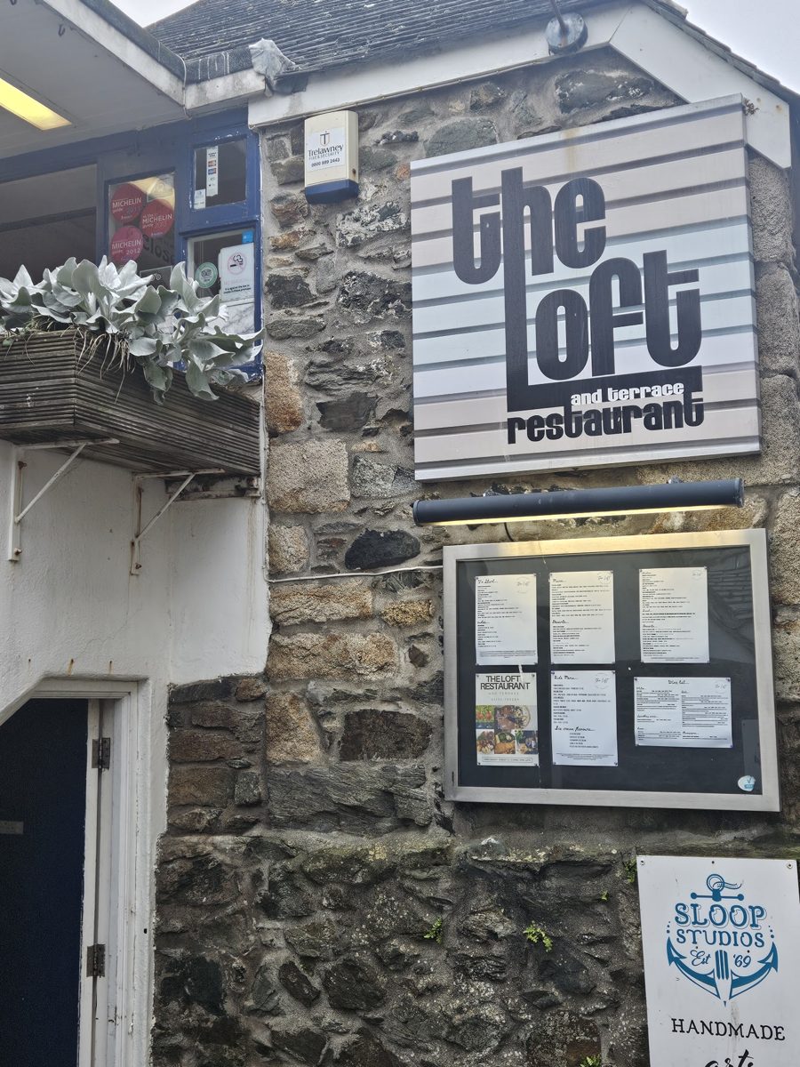 The Loft restaurant sign on its stone building